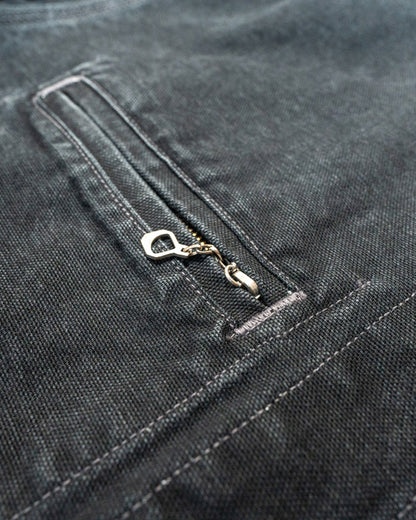 Close-up of a zipper on a dark denim background