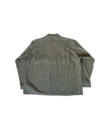 backside of a grey-greenish houndstooth shirt on a white background