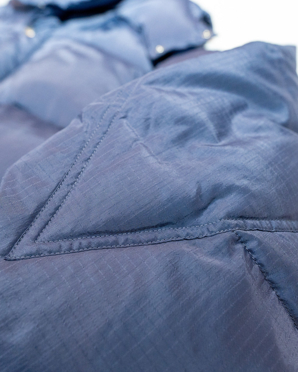 Close-up of a purple quilted jacket with stitching details