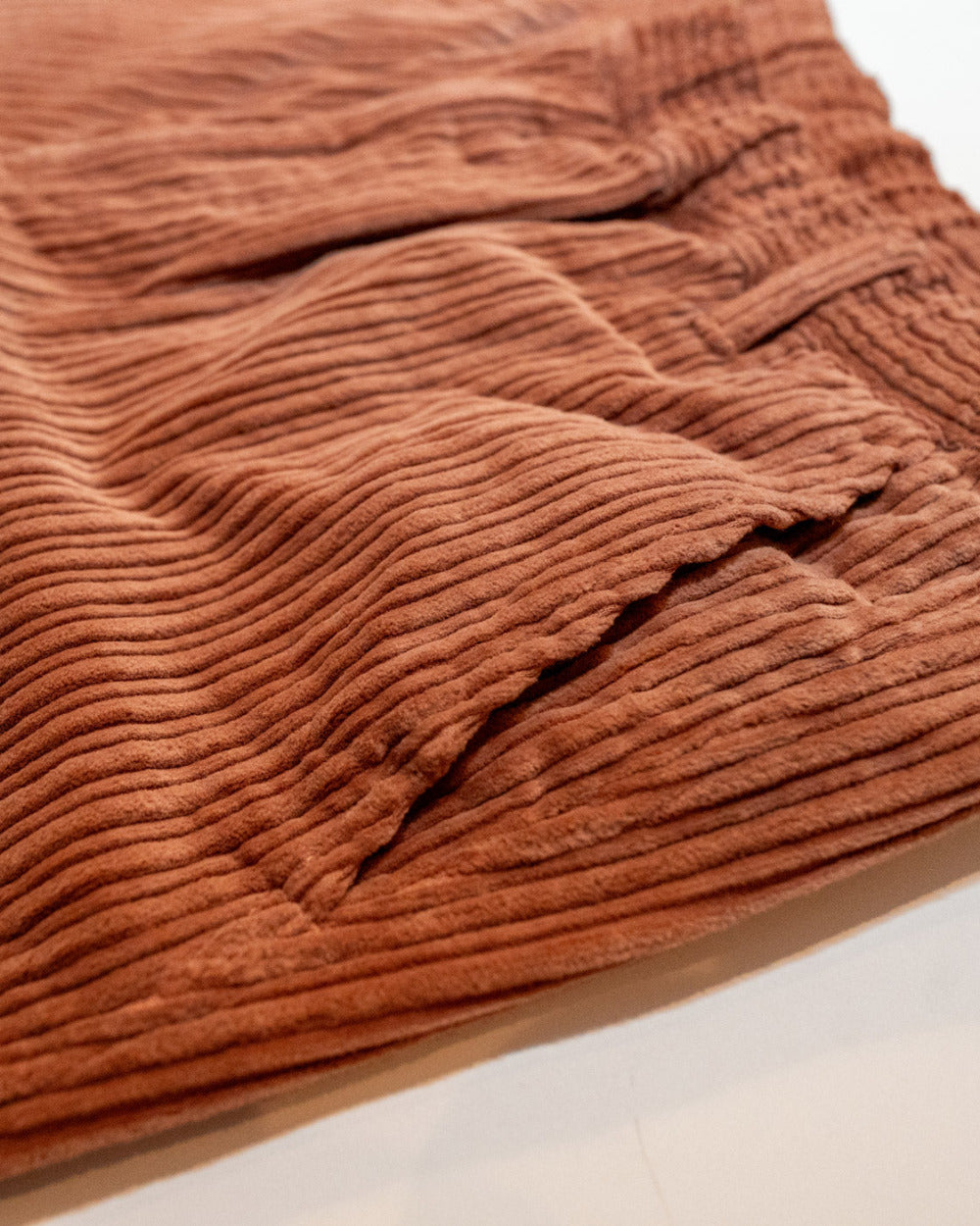 Close-up of brown textured fabric on a white background