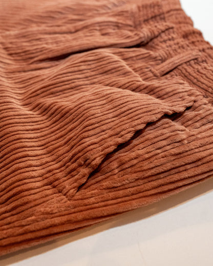 Close-up of brown textured fabric on a white background