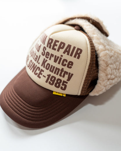 Brown and beige kapital cap with text on a white background