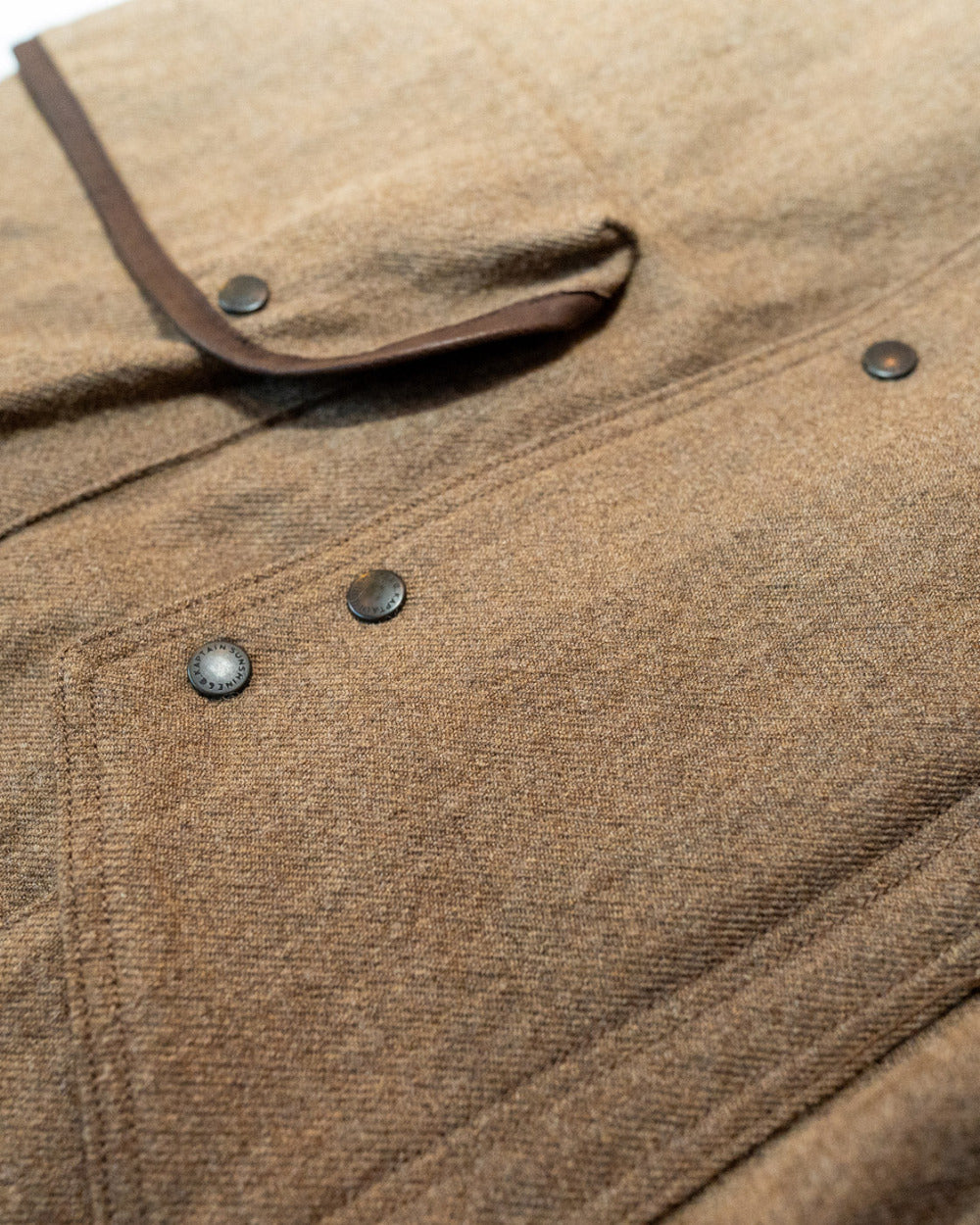 Close-up of a brown textured fabric with buttons