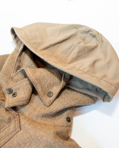 Close-up of a beige jacket with a hood on a white background