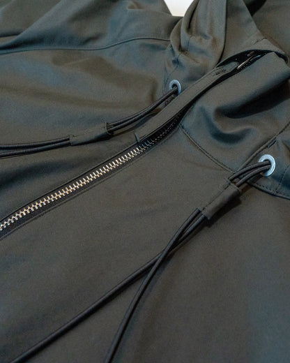 Close-up of a dark gray jacket with a zipper and drawstrings.