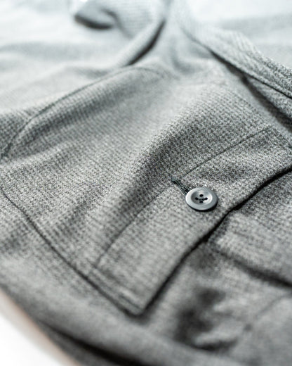 Close-up of a gray textured fabric with a button